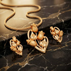 Costume Pendant Set (N64+E66-0346) in gold with rose design, styled on a marble surface – Anjali Jewellers